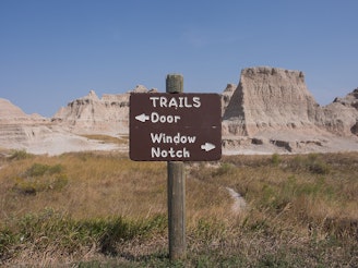 1280px-Badlands_National_Park_-_Door,_Window,_and_Notch_Trails_Sign.jpg